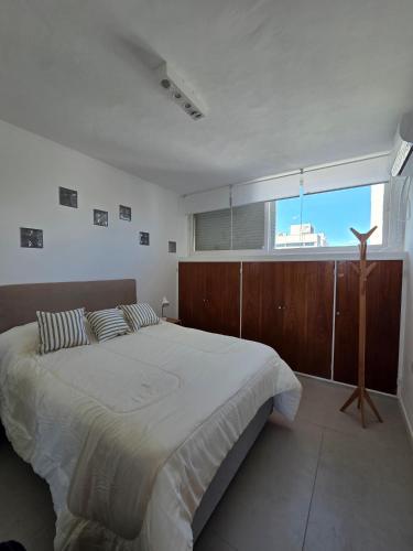 a bedroom with a large bed and a large window at Espacio 43 Terminal in La Plata
