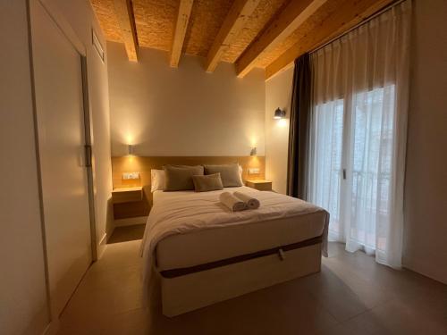 a bedroom with a bed and a large window at Hotel luna nueva in Tarragona
