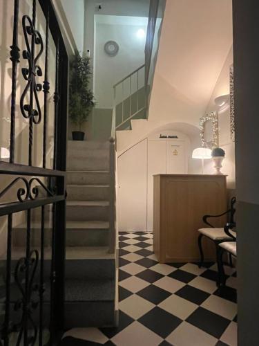 a hallway with a staircase and a checkered floor at Hotel luna nueva in Tarragona