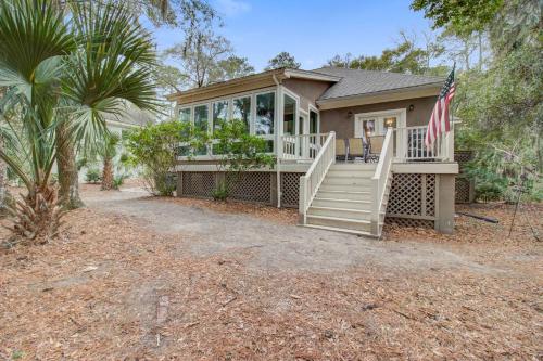 a small house with a porch and an american flag at Baywood 3074 in Seabrook Island