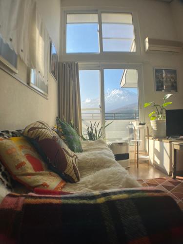 a bedroom with a bed with a large window at Fuji Hike Stay in Oyama