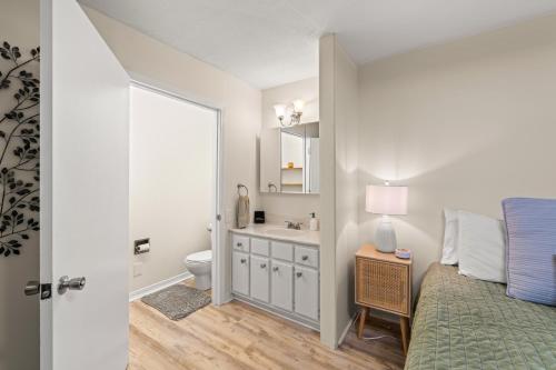 a bedroom with a bed and a sink and a toilet at Pigeon Forge Home in Pigeon Forge