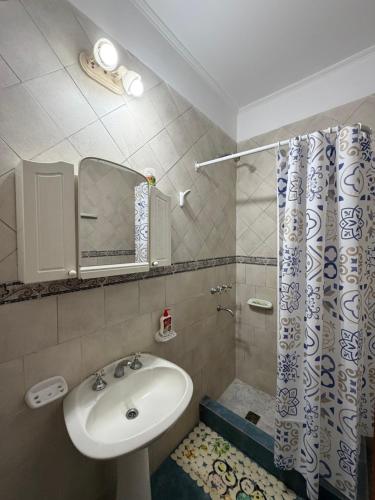 a bathroom with a sink and a shower at Ana y Fran in Villa Zorraquín