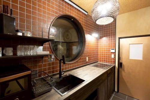 a bathroom with a sink and a mirror at 旅宿信長と忍者---1階-信長の間---NOBUNAGAtoNINJA in Omihachiman