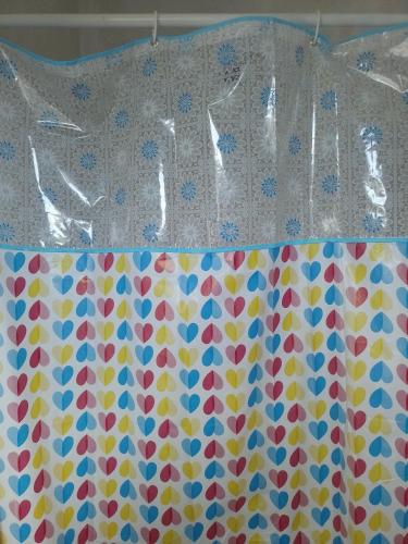 a shower curtain with a flower pattern on it at Passeio de quadriciclo com hospedagem in Guapimirim