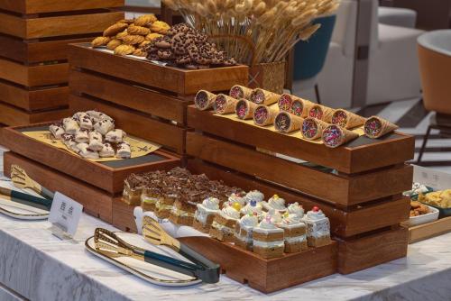 a display of different types of pastries on a table at Atour Hotel Dalian Xinghai Square in Dalian