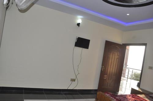 a room with a speaker and a tv on the ceiling at Ayub Residence Bhurban in Murree