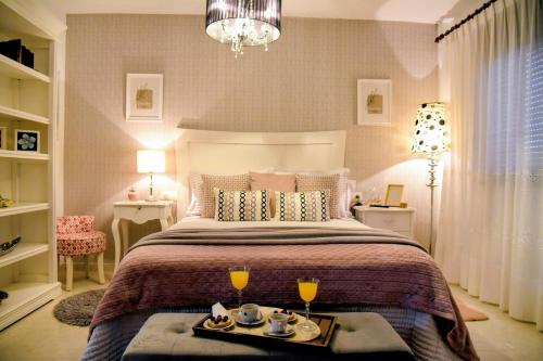 a bedroom with a bed with a tray of food on it at Casa Santamaria a 5min de Noia cerca de la playa in Lousame