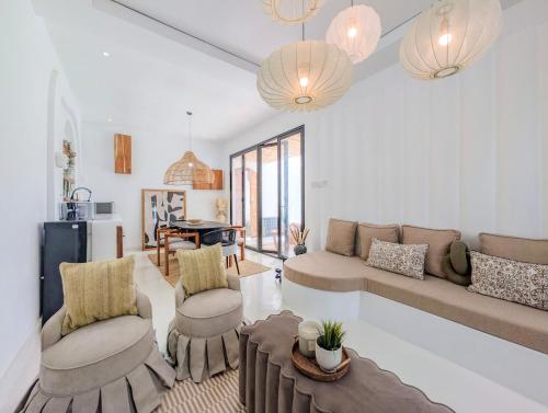 a living room with a couch and chairs and a table at Marram Villas 2 Prime Location in Paje