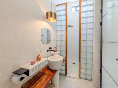 a bathroom with a white tub and a sink at Marram Villas 2 Prime Location in Paje