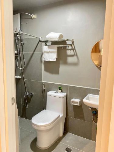 a bathroom with a toilet and a sink at Alpine Villas Cozy Staycation in Ulot