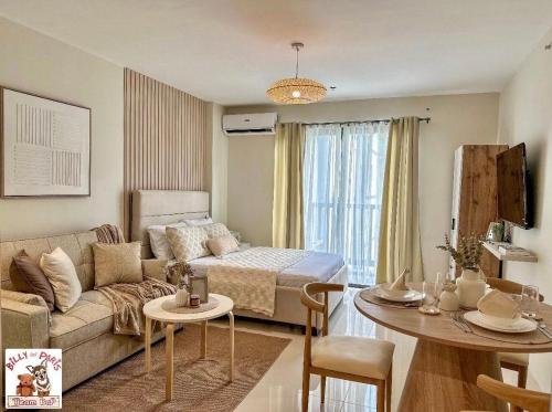 a living room with a couch and a table at Alpine Villas Cozy Staycation in Ulot