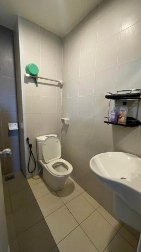 a bathroom with a toilet and a sink at Aisyah Studio D perdana in Kota Bharu