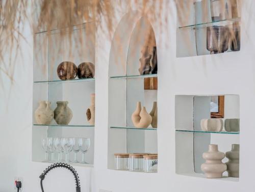 a shelf with vases and other items on it at Marram Villas 3 Prime Location in Paje