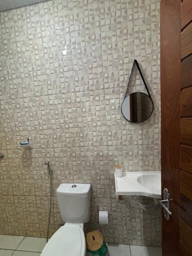 a bathroom with a toilet and a sink at Cajuí da Vila Atins in Atins