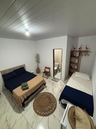 a bedroom with a bed and a mirror at Cajuí da Vila Atins in Atins
