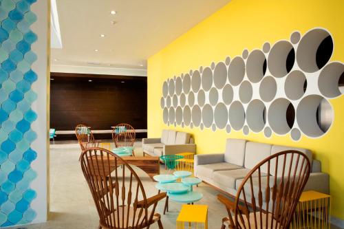 a lobby with chairs and a couch and a table at Krystal Urban Cancun & Beach Club in Cancún