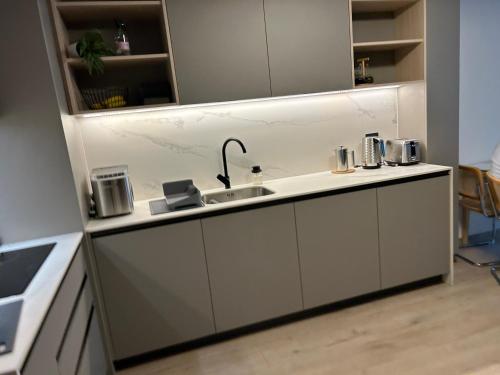 a kitchen with a sink and a counter top at Las Condes Avenida in Santiago