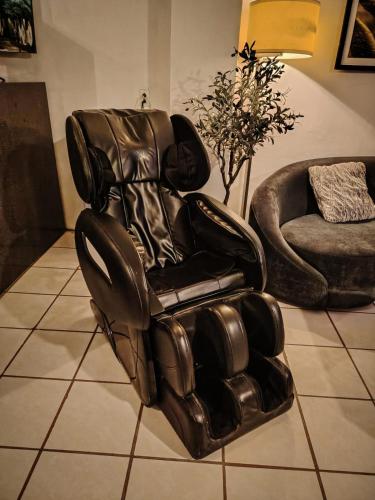a leather reclining chair in a living room at Hotel San José in San José del Cabo