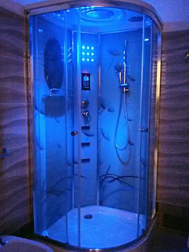 a bathroom with a shower with blue lights at Il Casale dei Principi in Lecce
