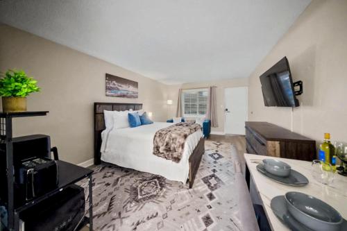 a bedroom with a bed and a tv and a table at Lux Mins To Atrium Health and Downtown Airport in Charlotte