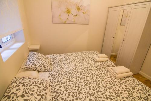 a small bedroom with a bed with towels on it at Apartamentos Aloha 2 Centro El Puerto de Santa Maria in El Puerto de Santa María
