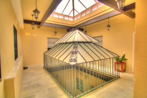 a large bird cage in a room with a window at Apartamentos Aloha 2 Centro El Puerto de Santa Maria in El Puerto de Santa María