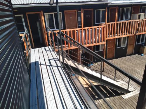a balcony of a house with a wooden deck at Hostal Egaña 228 in Puerto Montt