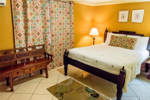 a bedroom with a bed and a bench in it at Aruba Surfside Marina in Oranjestad