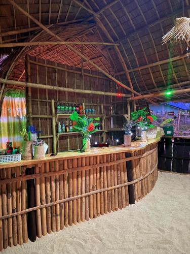 a bar in a building with a bamboo wall at Tress Maria's beach resort in Brother Islands