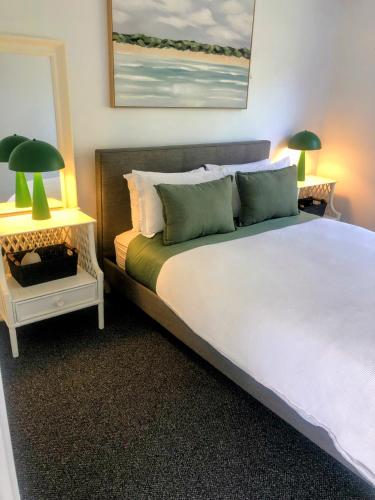 a bedroom with a large white bed with two lamps at Rye Hide Out - Rye beach retreat in Rye