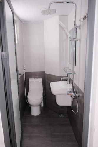 a small bathroom with a toilet and a sink at 5H homestay & Motorbikes For Rent in Hue