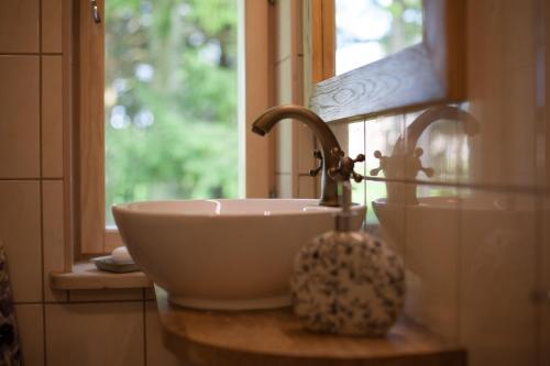 a white sink sitting on a counter next to a window at Nuutri Villa in Kärdla