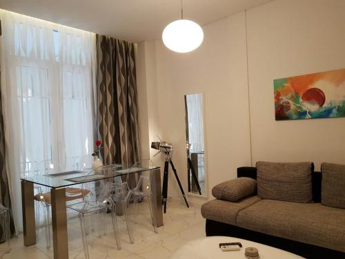 a living room with a glass table and a couch at Laura Aristotelous Square Apartment in Thessaloniki