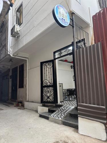 a door to a building with a blue sign on it at Hotel Hc Luxury Apartment in Hanoi