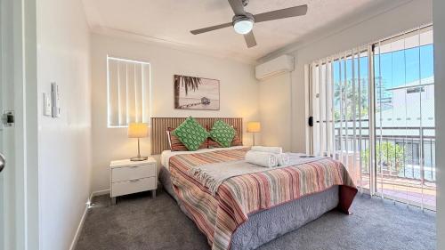 a bedroom with a bed and a large window at Santana Resort Surfers Paradise in Gold Coast