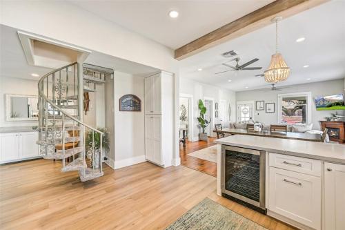 a kitchen and living room with a staircase in it at Magnolia Manor Heated Pool Coming Early 2026 in Galveston