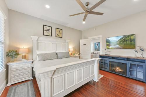 a bedroom with a large bed and a fireplace at Magnolia Manor Heated Pool Coming Early 2026 in Galveston