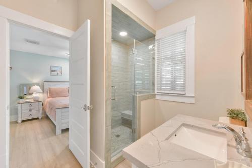 a bathroom with a shower and a bedroom with a bed at Magnolia Manor Heated Pool Coming Early 2026 in Galveston
