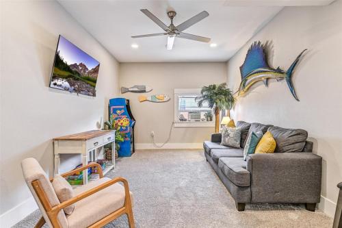 a living room with a couch and a ceiling fan at Magnolia Manor Heated Pool Coming Early 2026 in Galveston