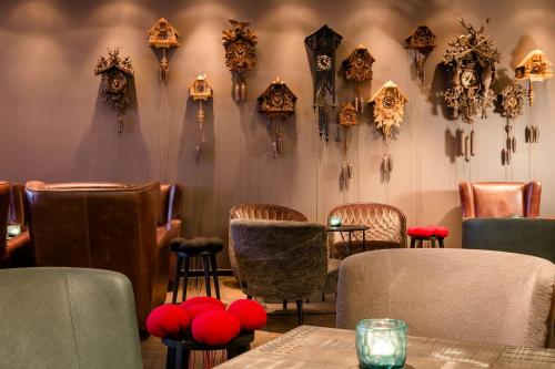 a restaurant with clocks hanging on the wall at Motel One Freiburg in Freiburg im Breisgau