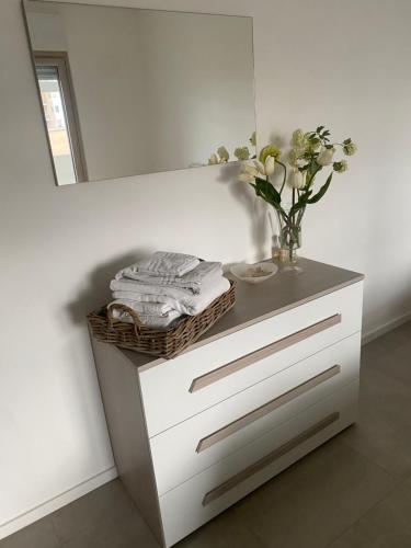 a white dresser with a mirror and a vase on it at Brezza di Bari, Terrace & Free Parking, family and group apartment by Leviora Collection in Bari