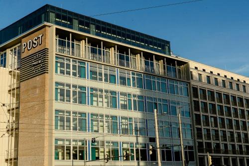 a large office building with a lot of windows at Motel One Leipzig-Post in Leipzig