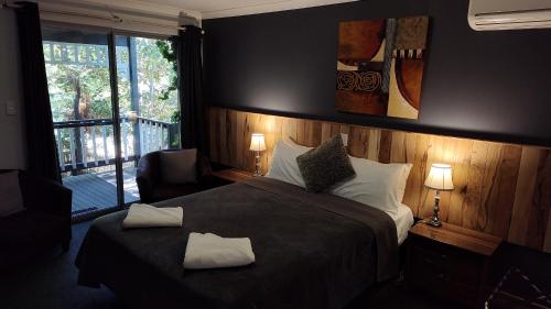 a bedroom with a bed with two towels on it at Adamsons Riverside in Margaret River Town