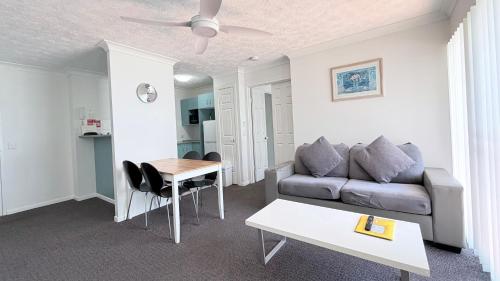 a living room with a couch and a table at Santana Resort Surfers Paradise in Gold Coast