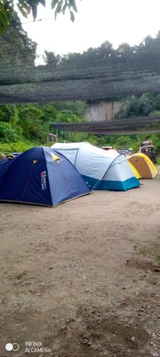 a group of tents parked in a field at Sikumbang camp in Bukittinggi