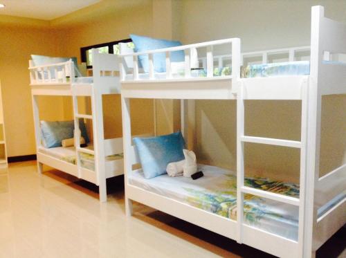 two white bunk beds in a room at Bayview Country Inn El Nido in El Nido