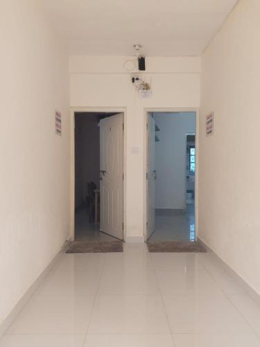 an empty room with white walls and white floors at Sai Sadan GuestHouse Goa in Calangute