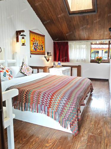 a bedroom with a large bed in a room at In Spring Country Courtyard in Lijiang in Lijiang