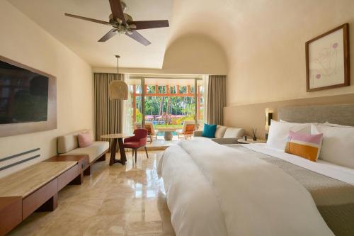 a bedroom with a large bed and a living room at The Westin Resort & Spa, Puerto Vallarta in Puerto Vallarta